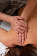 Fototapeta na wymiar Massagist performing back massage to female client.