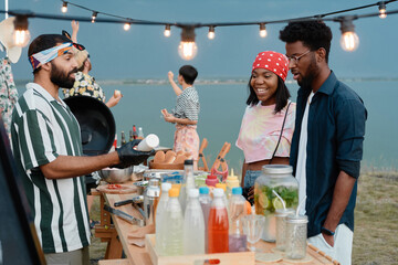 Young people buying hot dogs for lunch while they spending time on the beach