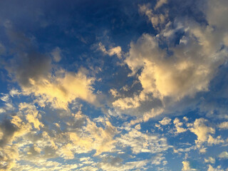 Natural background. Blue sky with clouds at sunset. Close-up.
