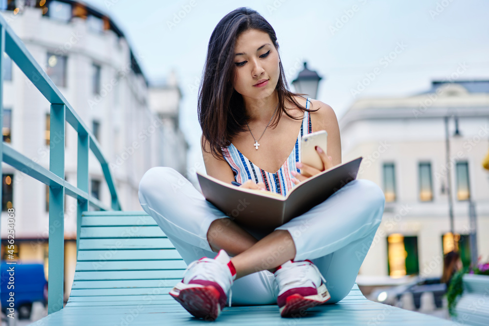 Poster young asian female student with education notepad using cellular application for informative researc