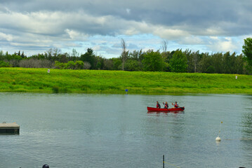 Boucherville, QC, Canada, 7-30-2021, three adults are kayaking in Lawrence (Laurent) River, islands...