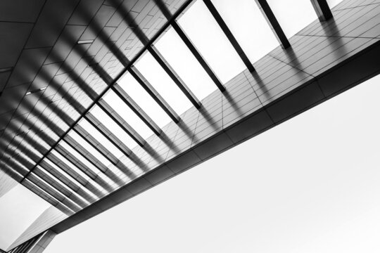 Urban Geometry, looking up to the building. Modern architecture, concrete, and glass. Abstract architectural design. Artistic minimalism image. Modern architecture concept black and white image.