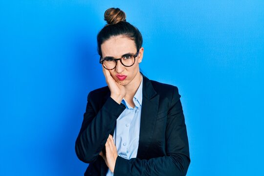 Young hispanic girl wearing business clothes and glasses thinking looking tired and bored with depression problems with crossed arms.