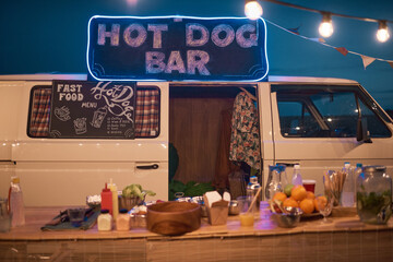 Image of outdoor bar in van with drinks and food at beach party