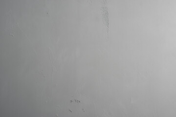 The surface is covered with light gray plaster with a soft light gradient. Backgrounds and textures.