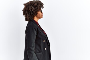 Obraz premium African american woman with afro hair wearing business jacket and glasses looking to side, relax profile pose with natural face and confident smile.