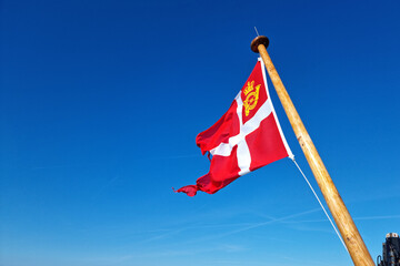 Flag of Post Danmark flutter in the blue sky background