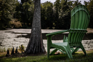 Green lawn chair overlooking the lake