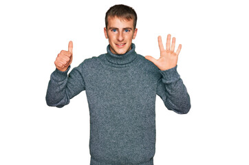 Fototapeta premium Young blond man wearing casual clothes showing and pointing up with fingers number six while smiling confident and happy.