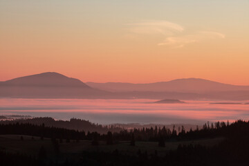 landscape with mountains and fog in the valleys in the morning