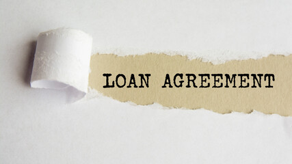 loan agreement. words. text on gray paper on torn paper background