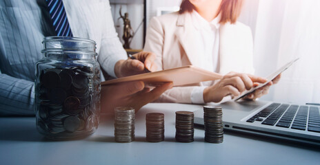 Male hand putting coins with money stack step growing growth and dollar bag. saving money, Concept finance business investment.