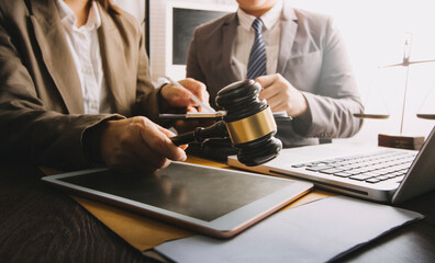 justice and law concept.Male judge in a courtroom on wooden table and Counselor or Male lawyer working in office. Legal law, advice and justice concept.