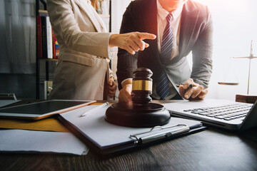 justice and law concept.Male judge in a courtroom on wooden table and Counselor or Male lawyer...