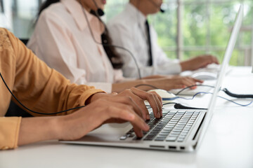 Business people wearing headset working actively in office . Call center, telemarketing, customer...