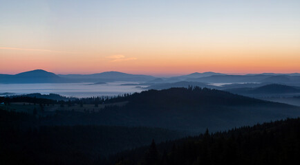 landscape with mountains and fog in the valleys in the morning