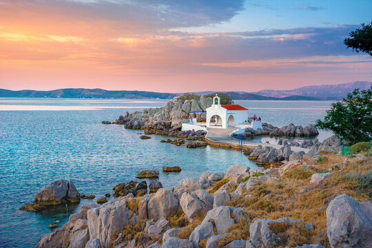 Little church of Agios Isidoros in the sea over the rocks, Chios island, Greece.