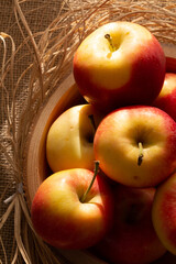 red apples in wooden bowl