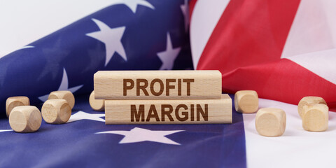 The American flag has wooden cubes and plaques that say - PROFIT MARGIN