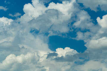 Cumuliform cloudscape on sky. Panorama. The sun is hidden.  Cumulonimbus clouds.