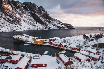 Mountain rural fishing village by the sea ocean winter snow houses