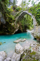 The mountain river flows under a stone bridge, Narnjo de Bulnes, Picos de Europa, Spain