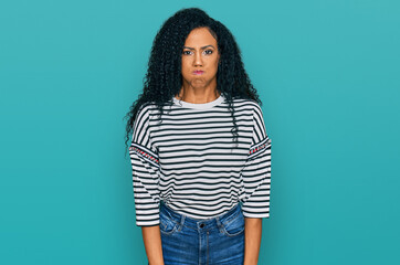 Middle age african american woman wearing casual clothes puffing cheeks with funny face. mouth inflated with air, crazy expression.