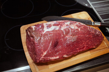 Raw Picanha steak cut on a wooden plate