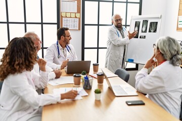 Obraz premium Group of middle age doctor discussing in a medical meeting at the clinic office.