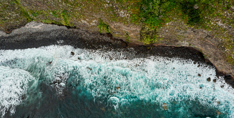 Amazing aerial view of crashing waves on rocks seascape.