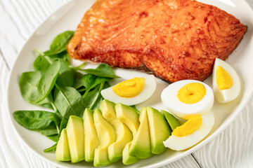 baked salmon fillet with eggs , spinach, avocado