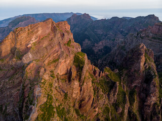 Aerial view of picturesque volcanic mountains at sunrise.