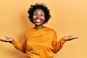 Young african american woman wearing casual clothes smiling showing both hands open palms, presenting and advertising comparison and balance