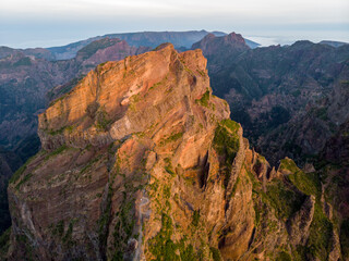 Aerial view of picturesque volcanic mountains at sunrise.