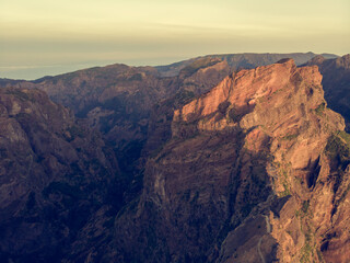 Fototapeta premium Aerial view of picturesque volcanic mountains at sunrise.