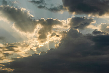 Fototapeta na wymiar Sunbeams piercing the clouds at dawn.