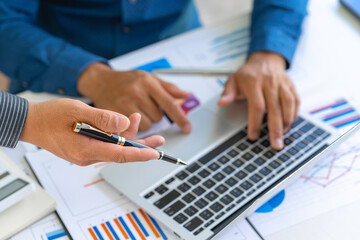 Business people discussing working and presenting the charts and graphs showing the results of their successful teamwork, the discussion aimed at reaching an agreement, Business concept.