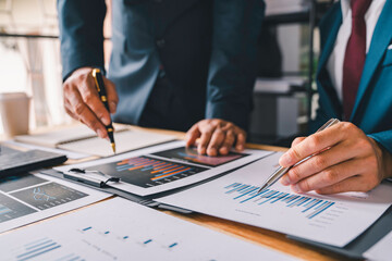 Business people discussion meeting, two business people talking, brainstorming to making a profit of company planning to analyze investment and marketing business strategy projection table in office.