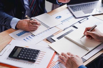 Business people discussion meeting, two business people talking, brainstorming to making a profit of company planning to analyze investment and marketing business strategy projection table in office.