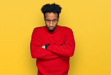 Fototapeta na wymiar Young african american man with beard wearing casual winter sweater skeptic and nervous, disapproving expression on face with crossed arms. negative person.