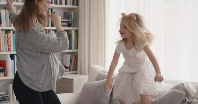 happy family dancing teenage girl having fun dance with little sister at home celebrating exciting weekend together 4k