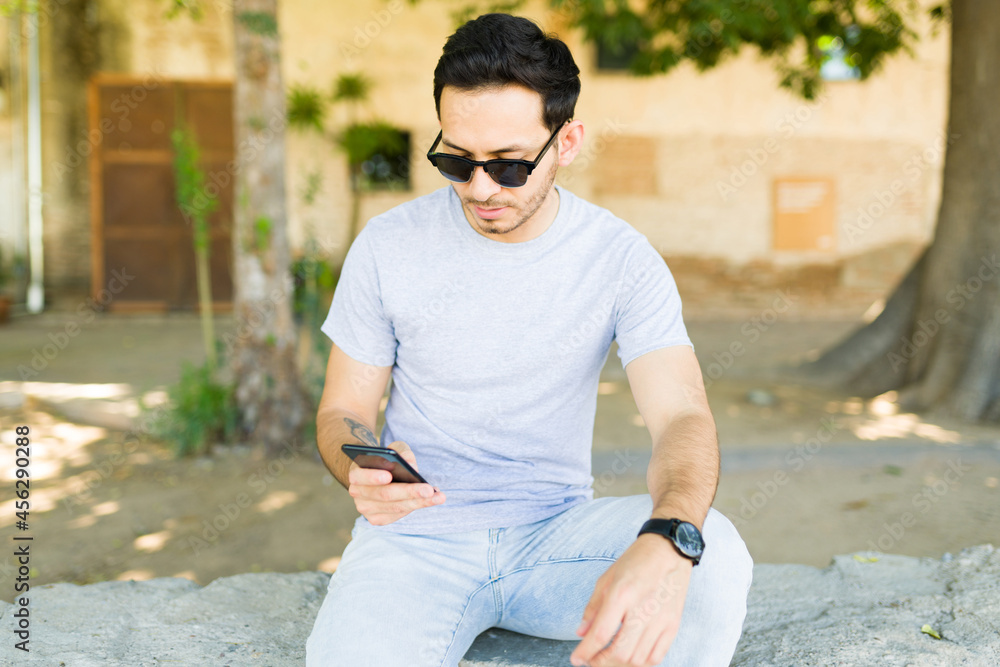 Wall mural handsome man at the park with a custom t-shirt