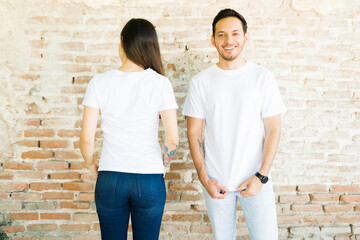 Obraz na płótnie Canvas Attractive couple made custom t-shirts