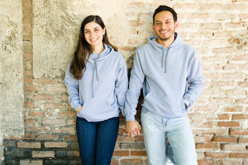 Fototapeta na wymiar Attractive couple with matching hoodies