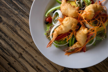 Fried shrimp on a plate with lettuce leaves. Asian style.