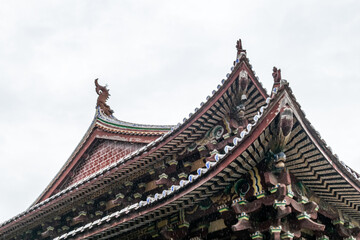 Fototapeta na wymiar Part of Chinese traditional Buddhist architecture in the rain