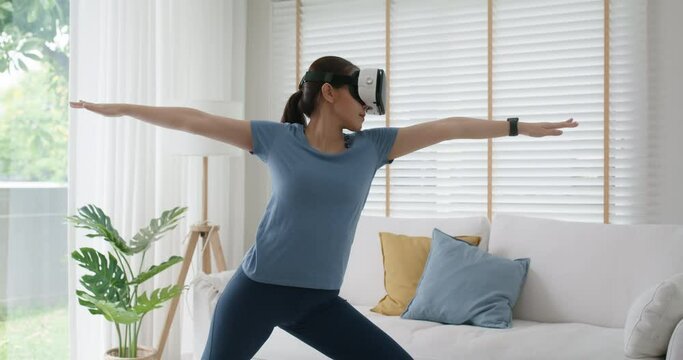 Asia girl teen people enjoy hobby happy deep zen remotely learn sport play online fitness body gym class fit life. Relax joy pose wear smart digital iot VR headset in AR app at home indoor.