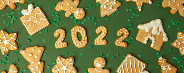 Winter Holiday banner- set of gingerbread on natural green background - Number Happy New Year 2022,...