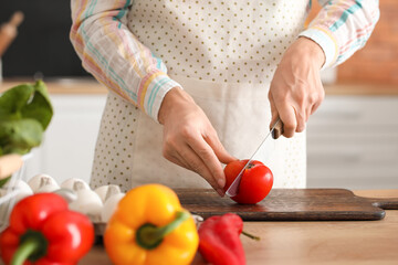 Young housewife cooking in kitchen at home