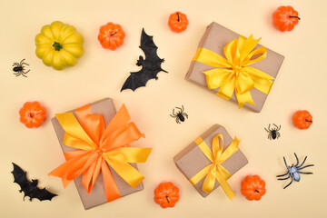 Festive Halloween background with gifts, pumpkins and spiders . Top view.